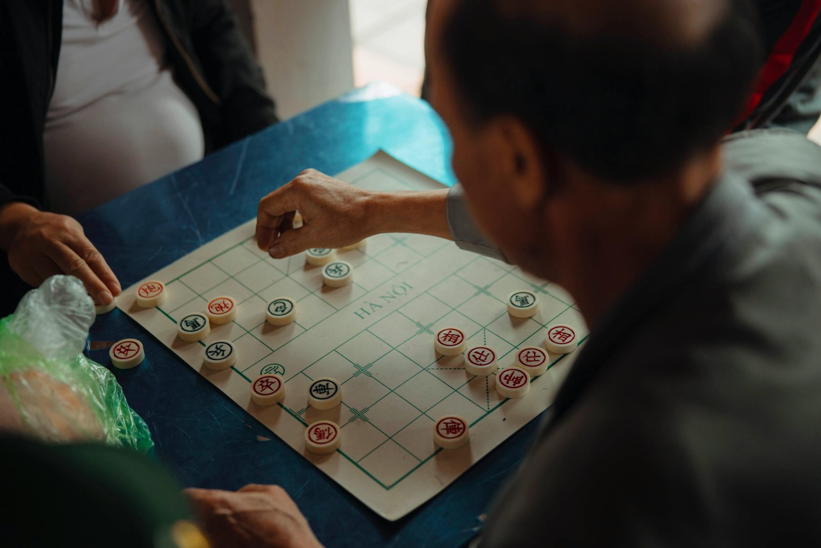 2 people playing a strategy board game